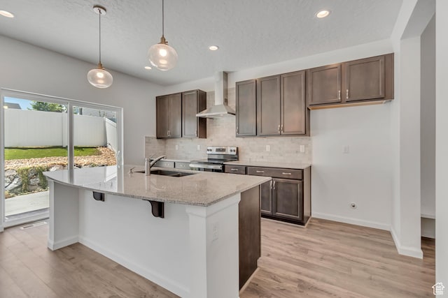 2123 N Wallflower Dr, Saratoga Springs, UT 84045 - kitchen featuring electric stove, wall chimney exhaust hood, tasteful backsplash, light wood-type flooring, and dark brown cabinets