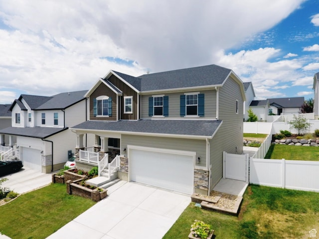 2123 N Wallflower Dr, Saratoga Springs, UT 84045 - view of front of property featuring a garage, covered porch, driveway, board and batten siding, and a gate