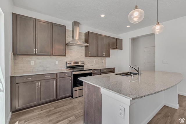2123 N Wallflower Dr, Saratoga Springs, UT 84045 - kitchen featuring stainless steel range with electric stovetop, wall chimney exhaust hood, light wood-style flooring, backsplash, and recessed lighting