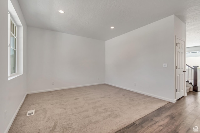 2123 N Wallflower Dr, Saratoga Springs, UT 84045 - carpeted empty room with healthy amount of natural light, recessed lighting, stairway, a textured ceiling, and wood finished floors