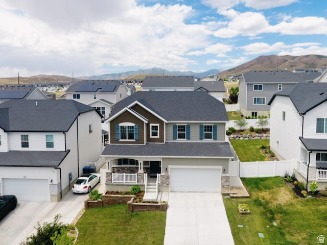 2123 N Wallflower Dr, Saratoga Springs, UT 84045 - traditional home with driveway, a residential view, a mountain view, an attached garage, and stone siding