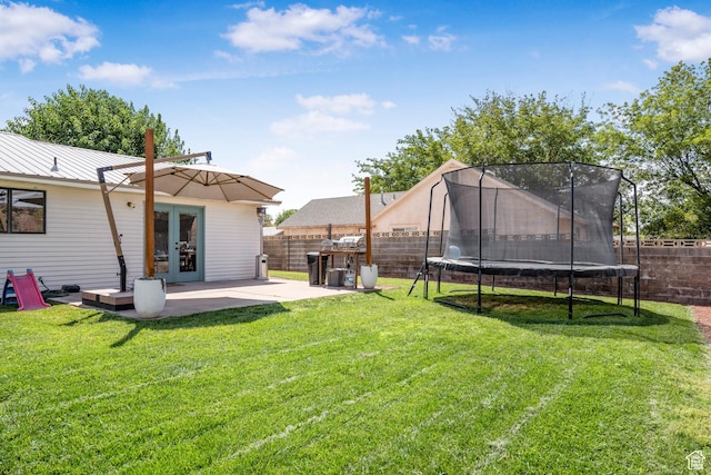 1655 Maplewood Way, St George, UT 84790 - fenced backyard featuring french doors, a trampoline, and a patio