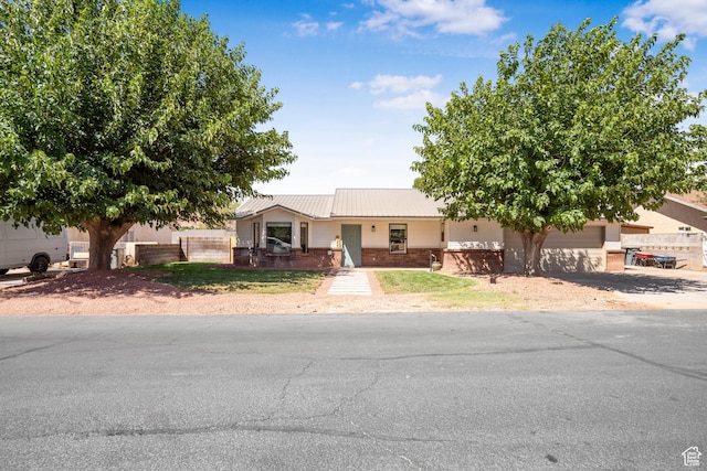 1655 Maplewood Way, St George, UT 84790 - view of front of house featuring brick siding, a garage, and a metal roof