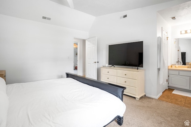 1655 Maplewood Way, St George, UT 84790 - bedroom with light carpet, connected bathroom, lofted ceiling, and light tile patterned flooring