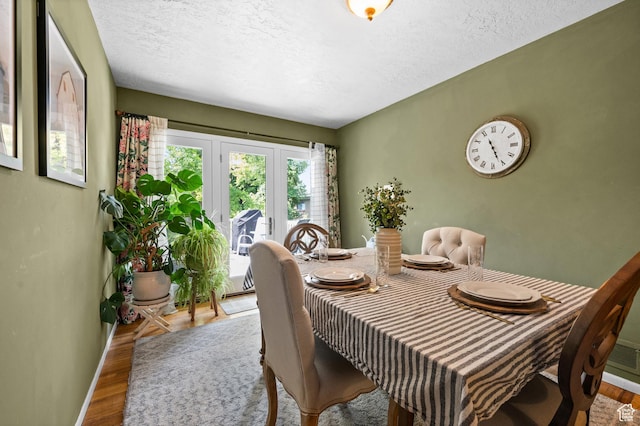 1770 E Vine St S, Salt Lake City, UT 84121 - dining area with french doors, wood finished floors, and a textured ceiling