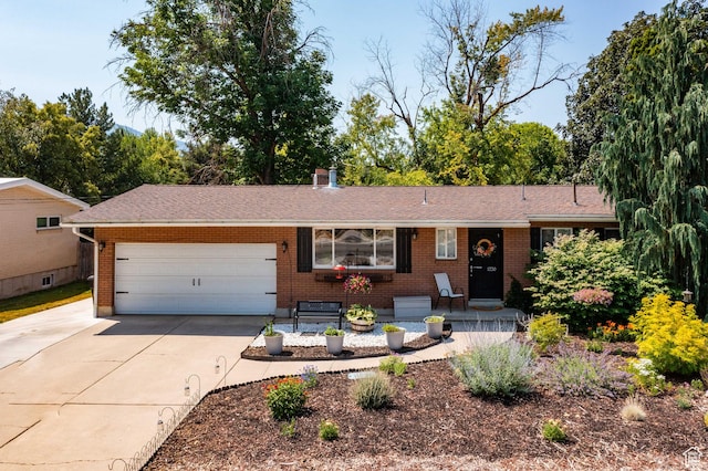 1770 E Vine St S, Salt Lake City, UT 84121 - ranch-style home featuring brick siding, concrete driveway, a garage, and roof with shingles