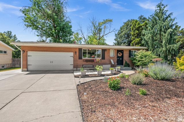 1770 E Vine St S, Salt Lake City, UT 84121 - view of front of house with driveway, an attached garage, and brick siding