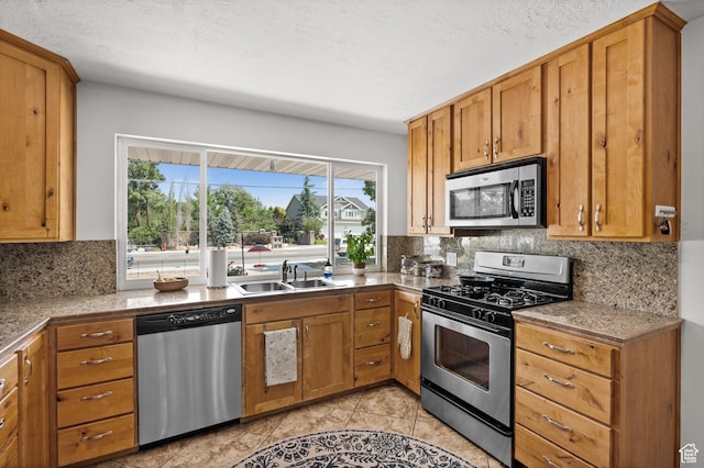 1770 E Vine St S, Salt Lake City, UT 84121 - kitchen featuring appliances with stainless steel finishes, backsplash, brown cabinetry, and light tile patterned flooring