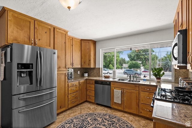 1770 E Vine St S, Salt Lake City, UT 84121 - kitchen featuring appliances with stainless steel finishes, tasteful backsplash, brown cabinets, and light tile patterned floors