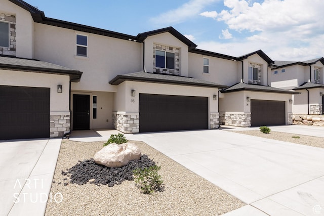 668 E Fiddlers Cove Dr Unit 35, Cedar City, UT 84721 - view of front of home with a garage, stone siding, stucco siding, and concrete driveway