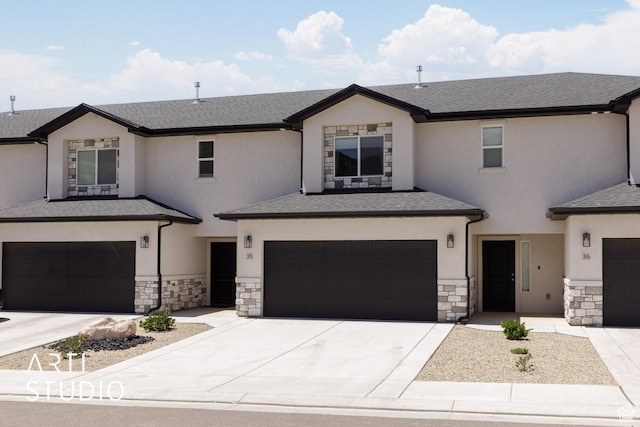668 E Fiddlers Cove Dr Unit 35, Cedar City, UT 84721 - view of front facade featuring an attached garage, stone siding, stucco siding, and driveway