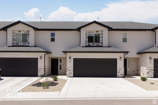 668 E Fiddlers Cove Dr Unit 35, Cedar City, UT 84721 - view of front of home featuring an attached garage, stone siding, and concrete driveway
