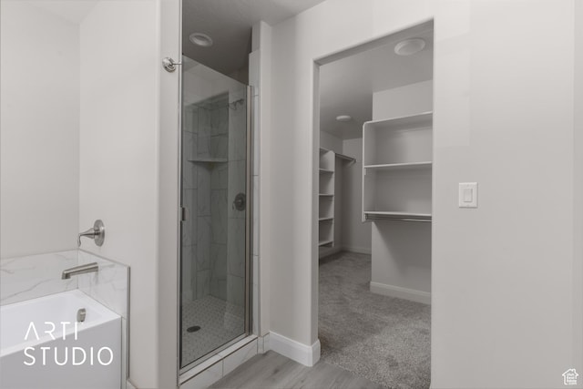 668 E Fiddlers Cove Dr Unit 35, Cedar City, UT 84721 - full bathroom featuring a bath, a stall shower, and a spacious closet