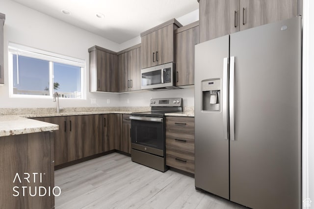 668 E Fiddlers Cove Dr Unit 35, Cedar City, UT 84721 - kitchen featuring stainless steel appliances, light wood finished floors, light stone counters, dark brown cabinetry, and recessed lighting