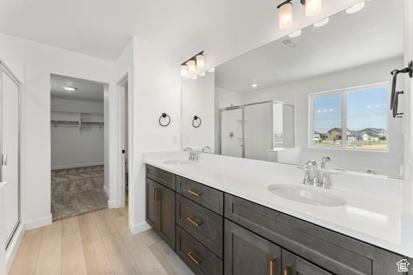 737 N Plainsman Dr Unit 108, Spanish Fork, UT 84660 - full bath with a shower stall, wood finished floors, a walk in closet, and double vanity