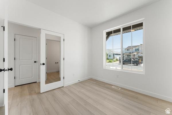 737 N Plainsman Dr Unit 108, Spanish Fork, UT 84660 - unfurnished bedroom featuring light wood finished floors and french doors