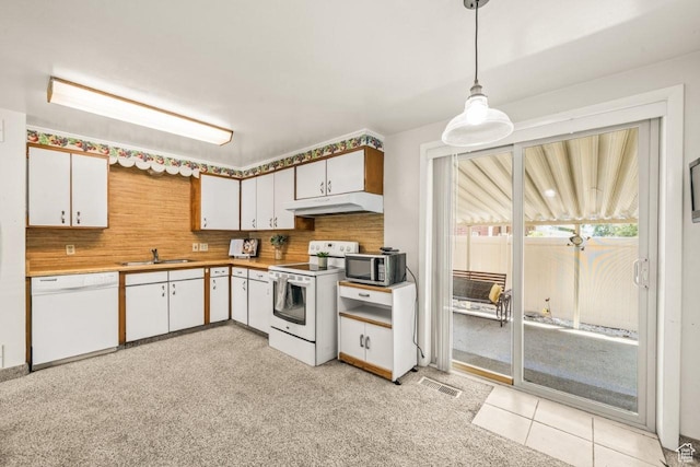 1632 Bennett St, Layton, UT 84041 - kitchen with white appliances, under cabinet range hood, white cabinetry, decorative light fixtures, and light countertops