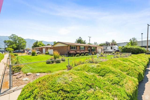 1632 Bennett St, Layton, UT 84041 - view of front facade with a mountain view, brick siding, and an attached garage
