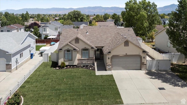 6515 S Mount Whitney Ln, West Valley City, UT 84118 - view of front of home featuring a gate, a garage, stucco siding, driveway, and a fenced backyard