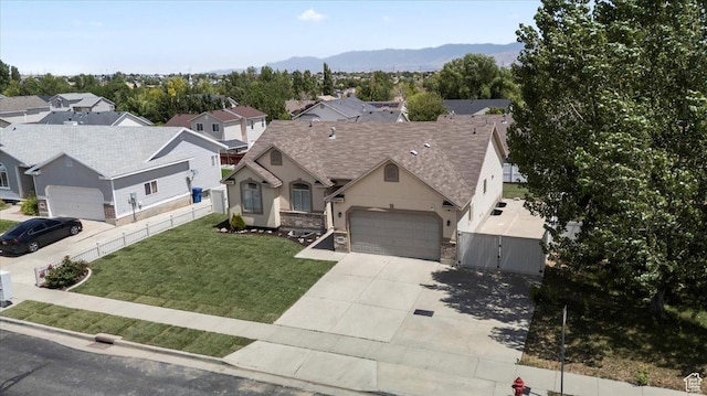 6515 S Mount Whitney Ln, West Valley City, UT 84118 - view of front of property with driveway, an attached garage, a gate, stone siding, and a mountain view