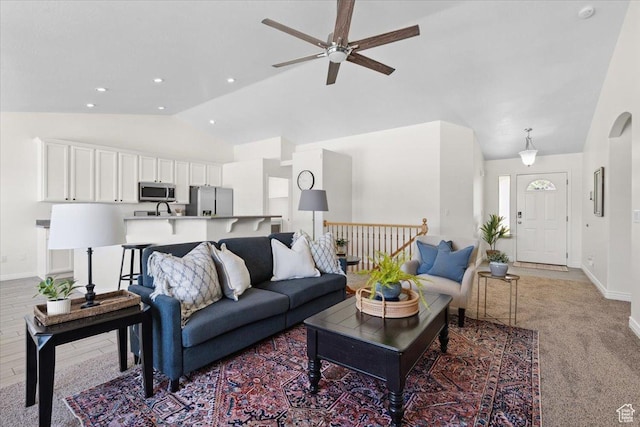6515 S Mount Whitney Ln, West Valley City, UT 84118 - living room featuring ceiling fan, light carpet, high vaulted ceiling, recessed lighting, and arched walkways
