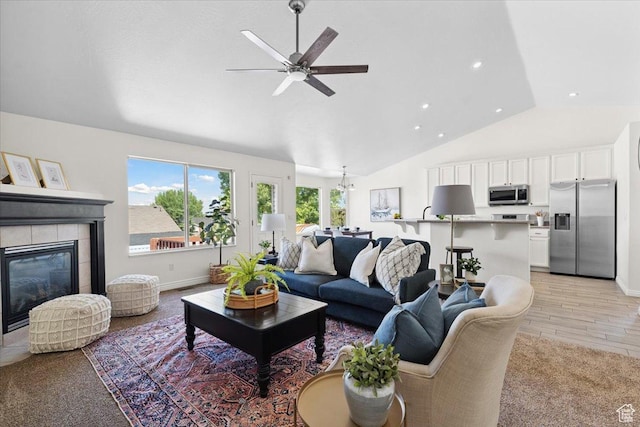 6515 S Mount Whitney Ln, West Valley City, UT 84118 - living room with a ceiling fan, a tile fireplace, light wood-style floors, recessed lighting, and high vaulted ceiling