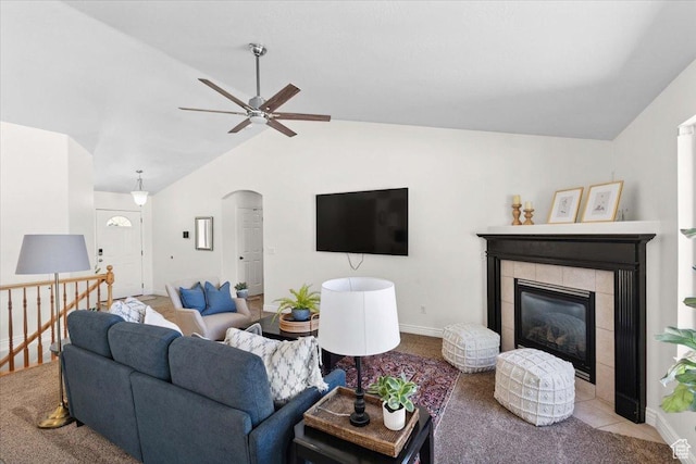 6515 S Mount Whitney Ln, West Valley City, UT 84118 - living room with vaulted ceiling, ceiling fan, arched walkways, and a tiled fireplace