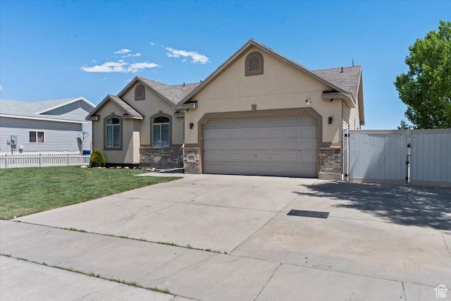 6515 S Mount Whitney Ln, West Valley City, UT 84118 - view of front of property featuring stucco siding, concrete driveway, an attached garage, stone siding, and a gate