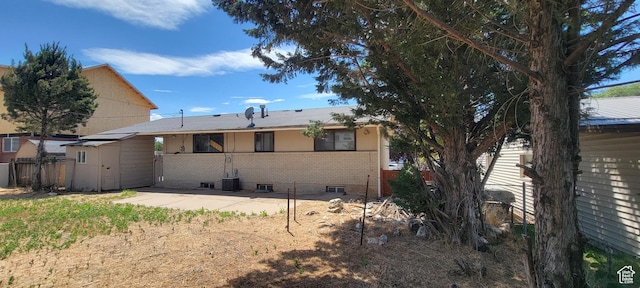 1226 N 450 W, Sunset, UT 84015 - back of property featuring brick siding, a storage unit, and a patio area