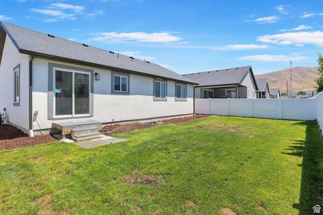 2362 E Quaking Aspen Ln, Eagle Mountain, UT 84005 - rear view of house featuring a mountain view, stucco siding, and roof with shingles