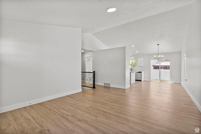 2362 E Quaking Aspen Ln, Eagle Mountain, UT 84005 - unfurnished living room featuring a chandelier, lofted ceiling, and light wood-type flooring