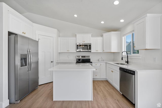 2362 E Quaking Aspen Ln, Eagle Mountain, UT 84005 - kitchen featuring stainless steel appliances, lofted ceiling, white cabinetry, light wood-style flooring, and a kitchen island
