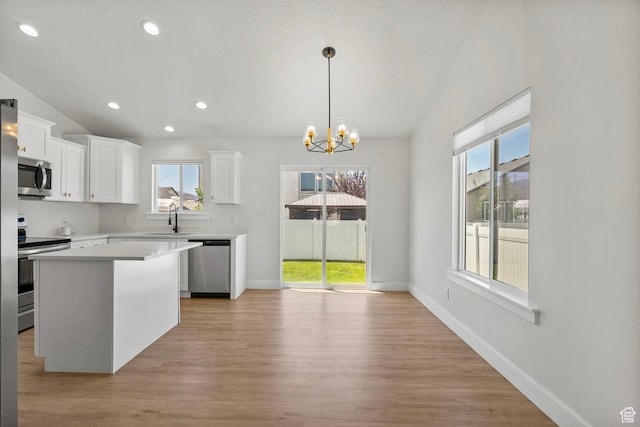 2362 E Quaking Aspen Ln, Eagle Mountain, UT 84005 - kitchen with stainless steel appliances, light countertops, a chandelier, light wood-style flooring, and white cabinetry