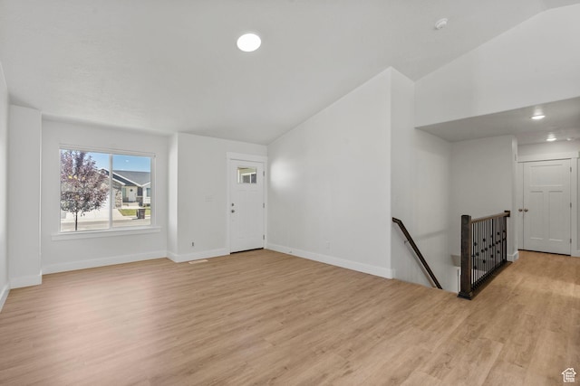 2362 E Quaking Aspen Ln, Eagle Mountain, UT 84005 - unfurnished living room featuring lofted ceiling and light wood-style floors