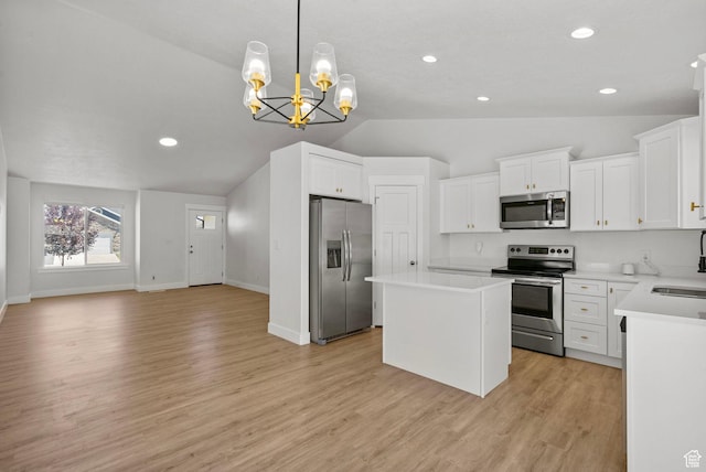 2362 E Quaking Aspen Ln, Eagle Mountain, UT 84005 - kitchen with appliances with stainless steel finishes, lofted ceiling, a center island, a chandelier, and light wood finished floors