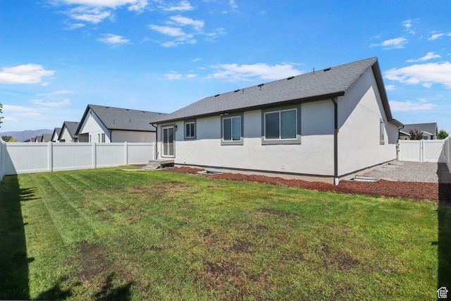 2362 E Quaking Aspen Ln, Eagle Mountain, UT 84005 - rear view of house with a fenced backyard, stucco siding, entry steps, and a shingled roof