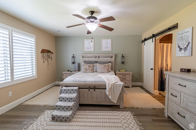 594 W 5450 S, Riverdale, UT 84405 - bedroom with a barn door, dark wood-style flooring, and ceiling fan