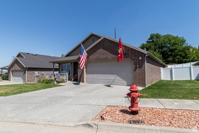 594 W 5450 S, Riverdale, UT 84405 - single story home with brick siding, a garage, and driveway