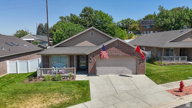 594 W 5450 S, Riverdale, UT 84405 - view of front of house featuring a porch, brick siding, an attached garage, and driveway