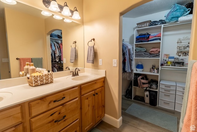 594 W 5450 S, Riverdale, UT 84405 - bathroom featuring double vanity, a walk in closet, and wood finished floors
