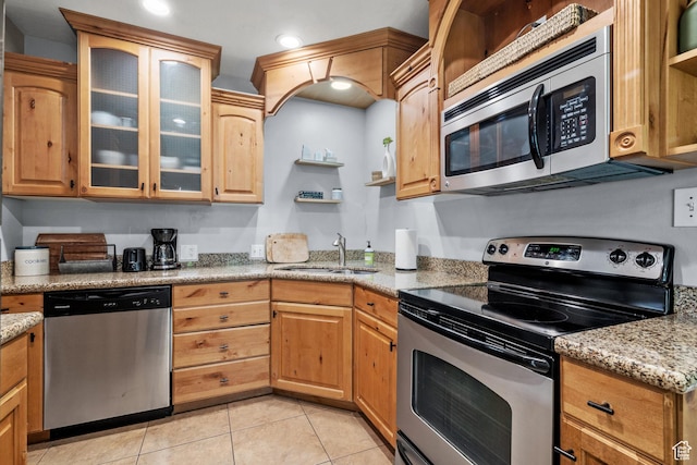 717 E 150 S, Provo, UT 84606 - kitchen featuring appliances with stainless steel finishes, open shelves, light tile patterned floors, glass insert cabinets, and light stone countertops