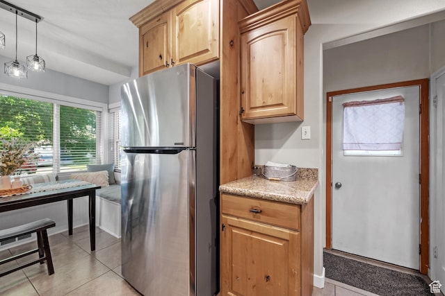 717 E 150 S, Provo, UT 84606 - kitchen featuring freestanding refrigerator, light tile patterned flooring, light stone counters, and light brown cabinetry