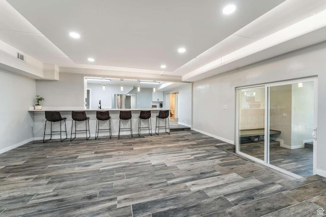 211 N 800 E, Bountiful, UT 84010 - kitchen with a kitchen breakfast bar, a peninsula, wood finished floors, recessed lighting, and light countertops