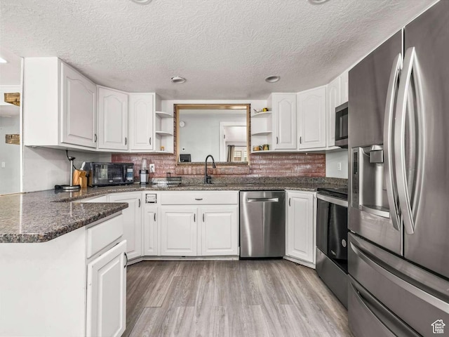211 N 800 E, Bountiful, UT 84010 - kitchen with appliances with stainless steel finishes, open shelves, white cabinets, a textured ceiling, and light wood-style floors