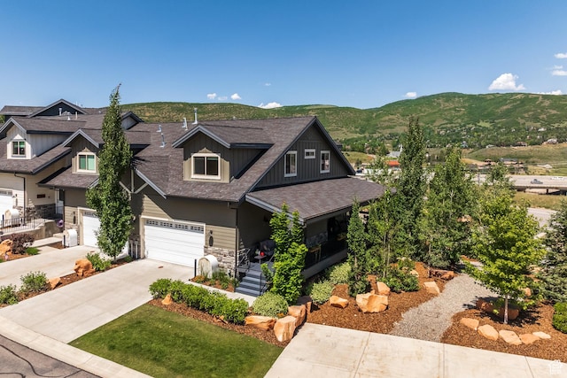 3302 Quarry Springs Dr, Park City, UT 84098 - craftsman-style house featuring driveway, roof with shingles, a mountain view, a garage, and stone siding