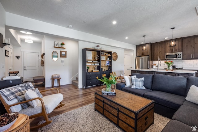 3302 Quarry Springs Dr, Park City, UT 84098 - living room with stairway, light wood finished floors, a textured ceiling, and recessed lighting