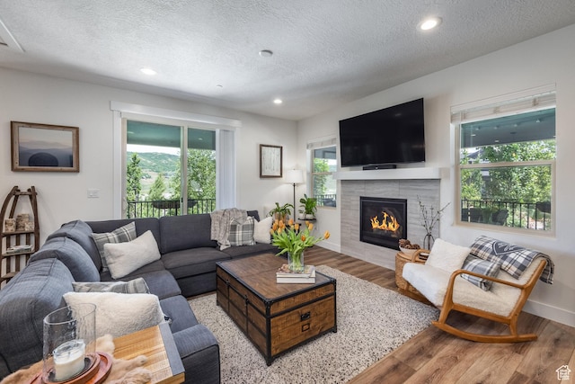 3302 Quarry Springs Dr, Park City, UT 84098 - living area with wood finished floors, a textured ceiling, a fireplace, and recessed lighting