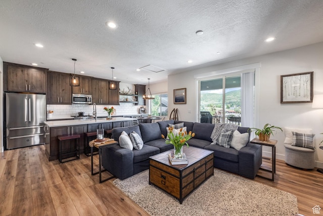 3302 Quarry Springs Dr, Park City, UT 84098 - living room featuring wood finished floors, a textured ceiling, and recessed lighting