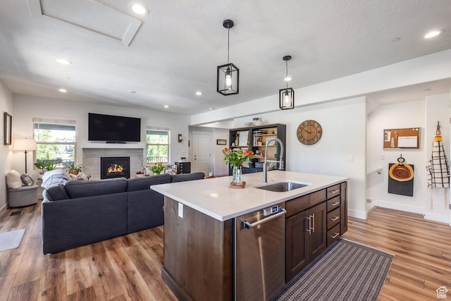3302 Quarry Springs Dr, Park City, UT 84098 - kitchen featuring stainless steel dishwasher, light countertops, a textured ceiling, light wood finished floors, and open floor plan