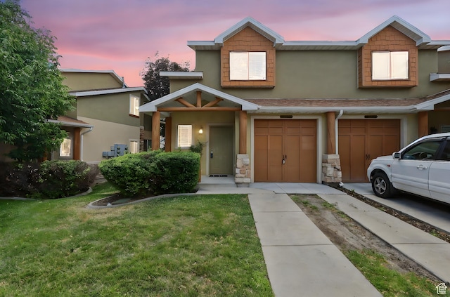 3901 W Pine Landing Way S, West Jordan, UT 84084 - view of front of home with driveway, a lawn, stucco siding, and a garage